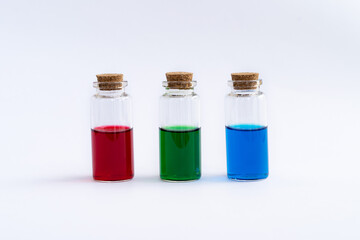 Three closed vials with colored contents on a white background.