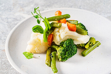 boiled vegetables on the white plate