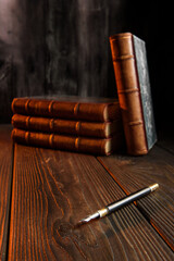 Composition with selective focus with books and pen for writing.