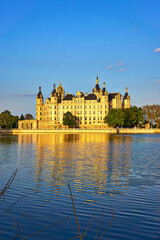 Schwerin Castle with natural sunlight and reflection in the lake.