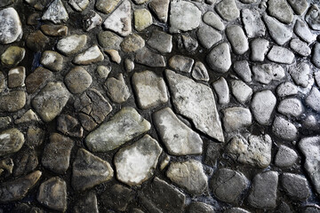 old stone pavement background / abstract pavement, large cobblestones, old road texture