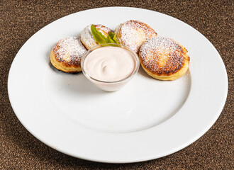 pancakes with sour cream on white plate