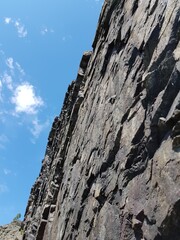 Stone rock on a background of blue sky