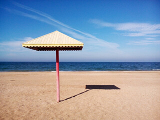 Beach umbrella stands by the sea