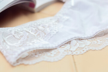 Lace on white womens bikini panties close-up. Delicate texture of the fabric of women's underwear