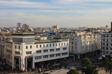 Fototapeta na wymiar CASABLANCA / MOROCCO-12.05.2019. Top view of Casablanca with many houses and people against a blue sky with clouds...