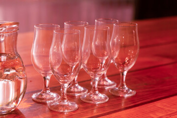 glass of wine bar set glasses decanter birthday celebration on a wooden red table