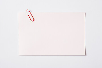 white sheet of paper for notes and paper clip

