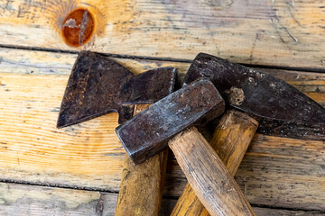 hammer ax old black assortment of building tools close up lie on weathered boards