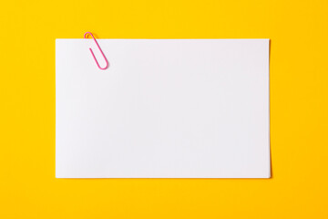 white sheet of paper for notes and paper clip
