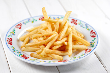 golden french fries on the wooden background