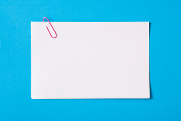 white sheet of paper for notes and paper clip

