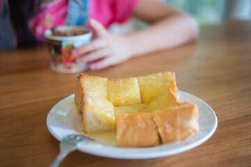 Toast bread with sweet milk in white plate.