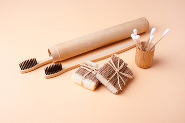 Zero waste. Wooden toothbrushes and handmade soap on peach background