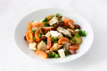 Grilled chicken salad with olives, feta cheese and tomatoes