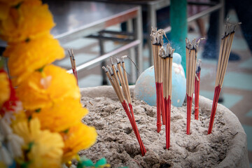 Incense sticks are burning on the joss stick vase