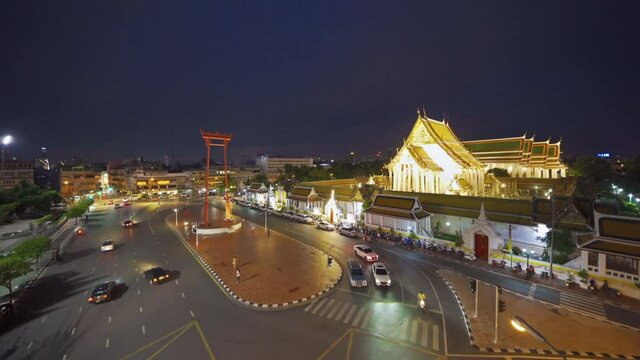 The Giant Swing or Sao Ching Cha monument with Wat Suthat temple at night in old town, Bangkok City, Thailand. Landmark tourist attraction. Thai architecture with travel trip concept.