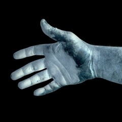 dirty dead male hand isolated on a black background close up