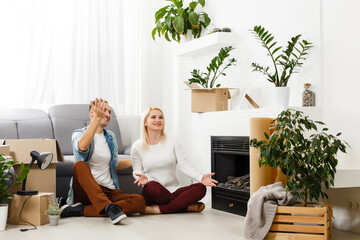 Family unpacking cardboard boxes at new home