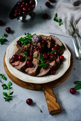 Roast beef with cherry sauce.style rustic.