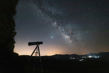 milky way and starry sky with telescope