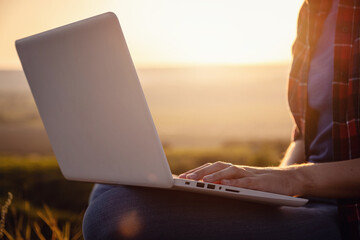 Girl working on her computer on the top of the mountain