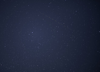 Star with satellite trail - night sky background.