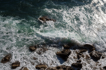 Ocean wave background breaking sea water rocky shore