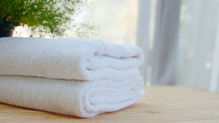 Obraz na płótnie Canvas Beautiful white folded towels placed on a white table for spa use,Spa accessories,Beautiful composition of spa , spa relax concept,