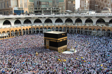 The Holy Kaaba. Crowd of people walking around Kaaba. Tawaf part during Umrah or Hajj © Nurlan