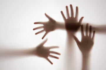 shadow of a hands behind transparent paper