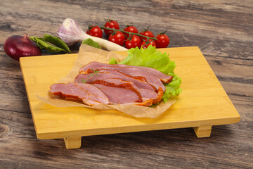 Sliced smoked duck breast served salad