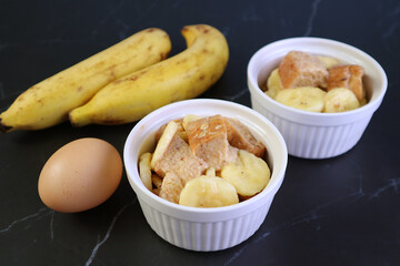 Uncooked Ingredients Ready for Baking Banana Bread Pudding in a Small Ceramic Baking Bowl