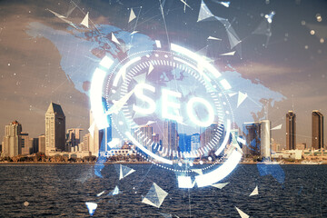 SEO hologram on city view with skyscrapers background double exposure. Search optimization concept.