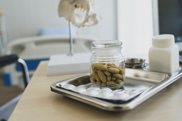 Medicine pill on table in doctor working room at hospital , Health care and medical concept wiht copy space