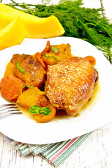 Chicken roast with pumpkin and dried apricots on napkin