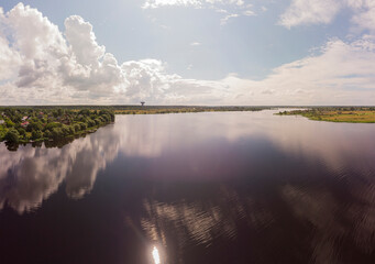 Magnificent panorama from a high point on the river, forest and beautiful sky on a Sunny day.