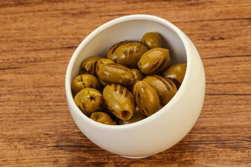 Green grilled olives in the bowl