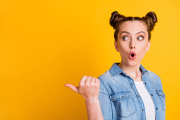 Closeup profile photo of funny teen lady open mouth two buns direct thumb finger side empty space...