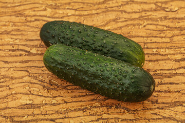 Green fresh cucumbers over background