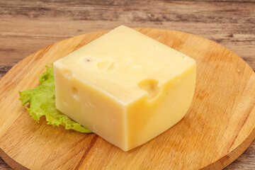 Emmental cheese over wooden board