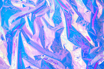 Blurred abstract Modern pastel colored holographic background in 80s style. Crumpled iridescent...