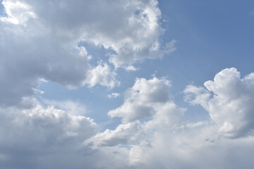 Fototapeta na wymiar white clouds fly across the blue sky
