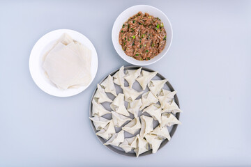Traditional Chinese food wonton is placed on agray plate.