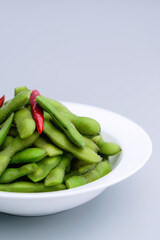 A traditional Chinese delicacy in solid color, boiled soybeans in brine. Chinese traditional food boiled soybean