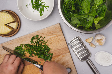 
Healthy food concept. Cooking fresh green spinach with cheese.