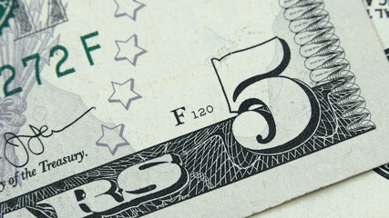 Element of American cash banknote 5 dollars. Macro photography