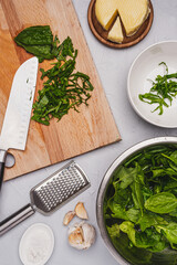 
Healthy food. Cooking fresh spinach with delicious cheese.