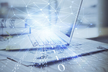 Double exposure of laptop computer and technology theme hologram. Concept of freelance work.