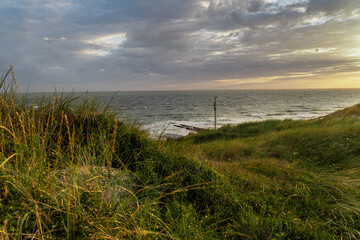 Photograph at the beach and dunes moments before the sun sets in the southwest of the Netherlands. 